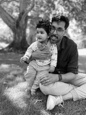 Gurvinder, the photographer behind Confetti & Frame, with his child at the park