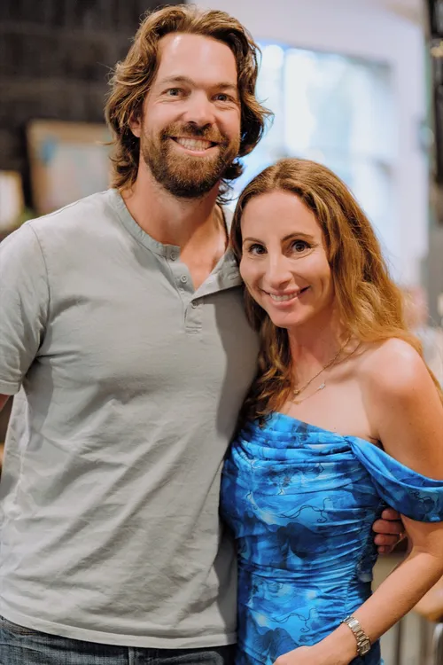 The birthday guest of honour and his partner smile together at his 40th birthday party.
